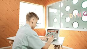 Back view of high school student working on laptop analysis data at STEM science class. Smart happy caucasian boy learning to coding engineering prompt or programming system at STEM class. Edification - Powered by Shutterstock - Get 15% off with code: PIKWIZARD15