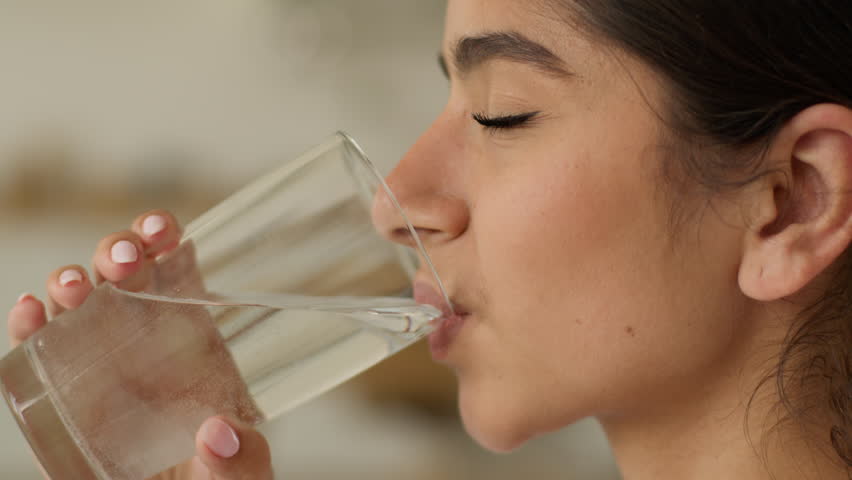 Health problem medicine medication unhealthy ill sick Hindu woman Indian girl Arabian female at home take drug pill remedy drinking glass water drink refresh vitamins supplement healthcare painkiller