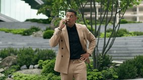 Angry mad aggressive businessman African American man business male guy manager employer leader company CEO talking mobile phone arguing argument trouble quarrel work problem discuss in city downtown - Powered by Shutterstock - Get 15% off with code: PIKWIZARD15