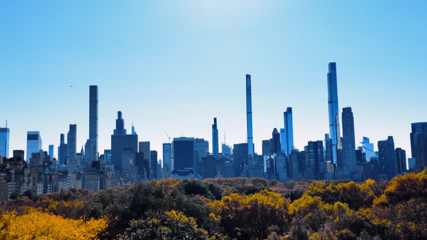 Spinning shot of Manhattan Sky line New York. Golden autumn in Central park park. Warm weather. Beautiful day, blue sky. Skyscrapers SpinShot, Rotating camera movement, spin shot,
