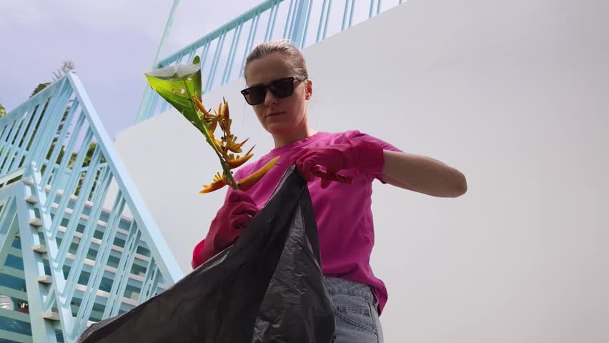 A young woman trims her beautiful garden 