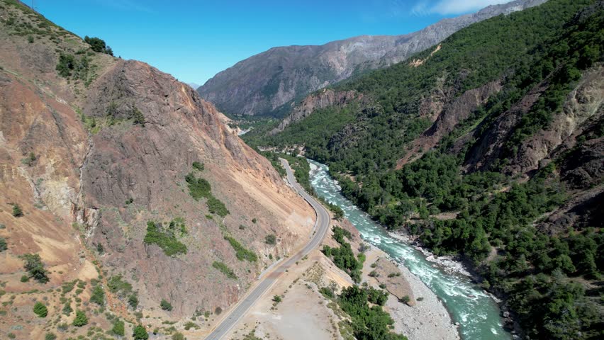 Aerial view of the Maule River, between mountains of the Andes mountain range.