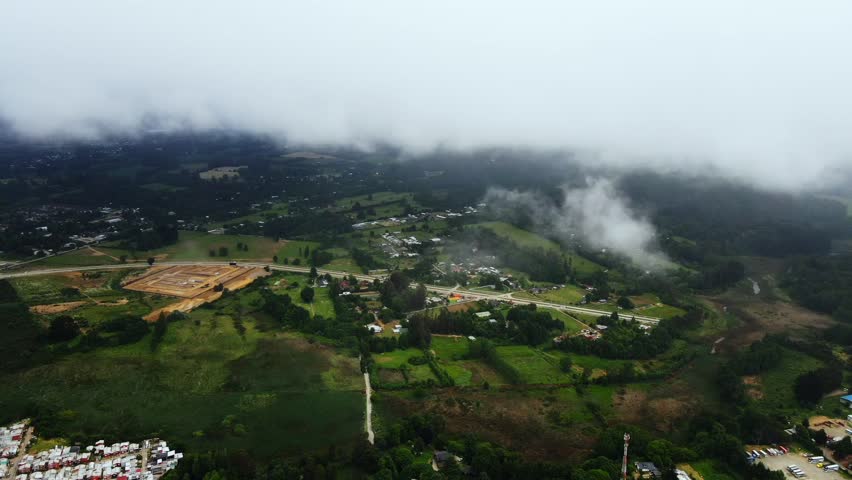 Clouds hover over the green village.