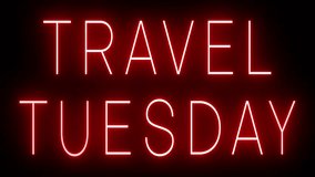 Flickering red retro style neon sign glowing against a black background for TRAVEL TUESDAY - Powered by Shutterstock - Get 15% off with code: PIKWIZARD15