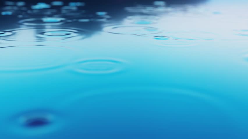 The beautiful ripples spreading across the water surface created by raindrops or water droplets.