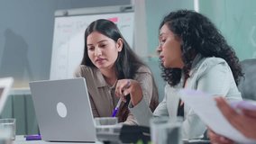 Young corporate office female colleagues or coworkers brainstorming, discussing and working together on an office project or assignment to solve business queries in modern a start up workplace meeting - Powered by Shutterstock - Get 15% off with code: PIKWIZARD15