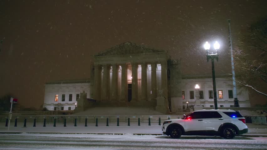 Supreme Court of the United States in Washington DC in a night winter, USA. Police car near Supreme Court of the USA in Washington DC.