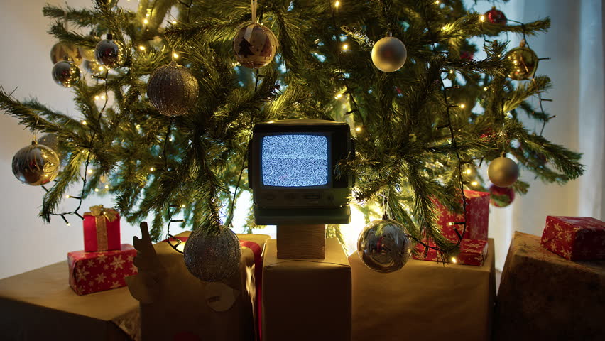 Vintage Television With Static Signal Under Bright Christmas Tree