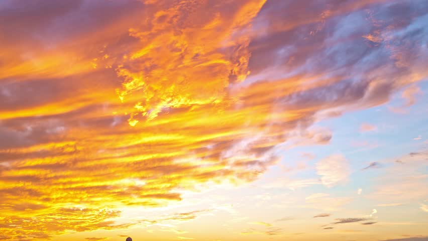 Sunset Sky timelapse. Moving clouds and sunset. Clouds float through the evening. Dusk twilight sky time lapse. Dramatic skies are moving. Cumulus and cirrus on storm. Sunrise cloudscape.
