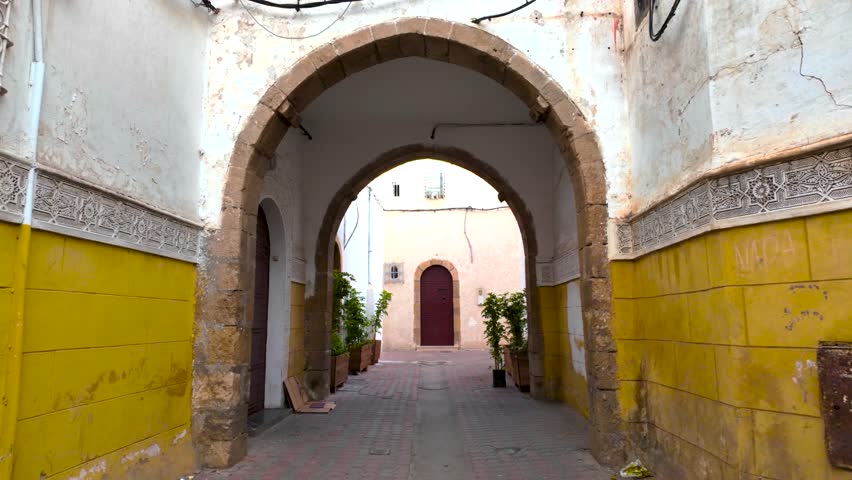 Casablanca, Morocco - December  02 2024 : a narrow street in the Houbous neighborhood of Casablanca, Morocco, featuring traditional Moroccan architecture with intricate tile work ,, a big heritage