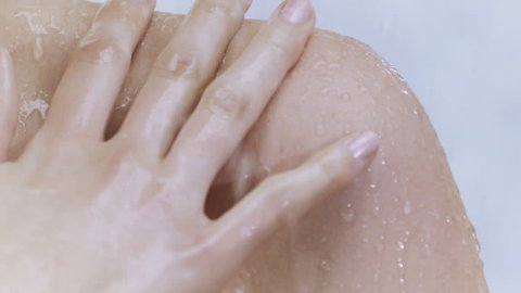 Young woman taking a shower in slow motion