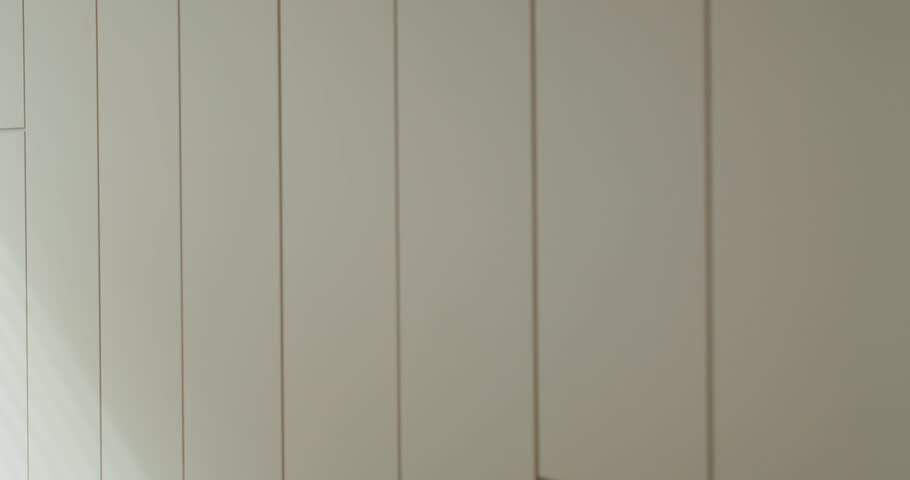 Sleek, minimalist interior design captured in an image showcasing white wall panels with subtle shadow lines adding depth and texture. Minimalist White Wall Panels with Elegant Shadow Lines