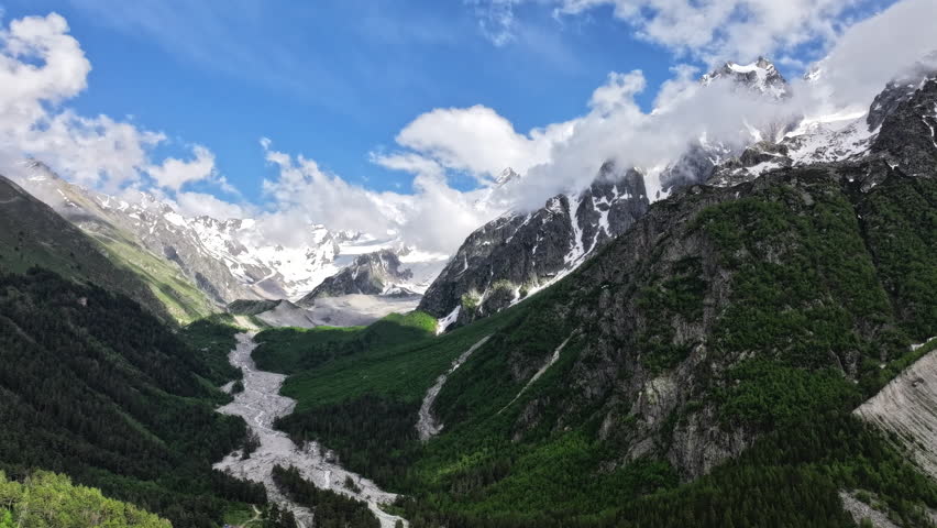 Clouds moving over mountain valley timelapse