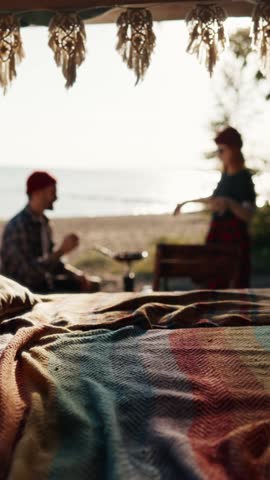 Campers enjoying good weather in sunny morning when cooking breakfast, motorhome trip across country. Man and woman resting on river shore in summertime, independent travelers, view from campervan