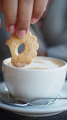 Dipping a cookie in coffee creates a uniquely perfect snack experience