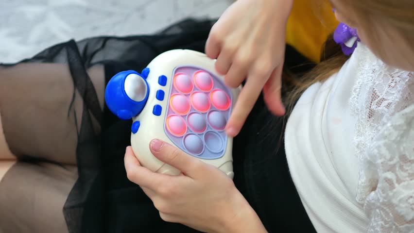 The hands of a little girl playing a modern children