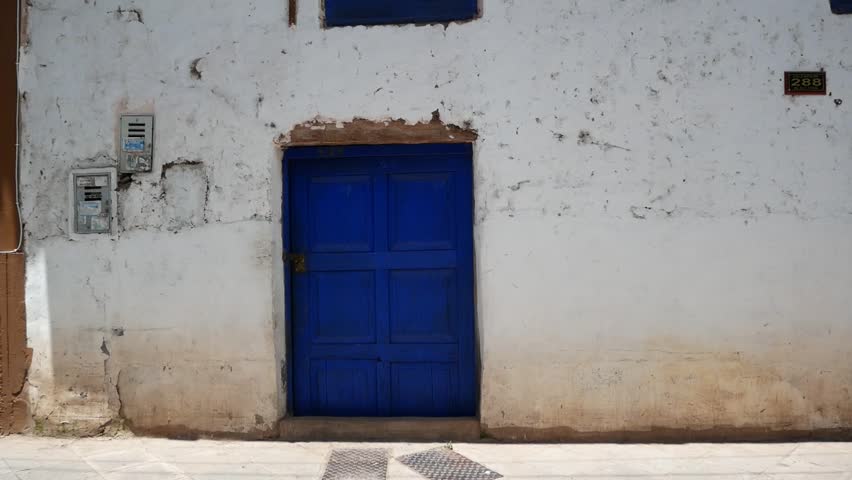 Worn and Old House with a Blue Wooden Door in Pisac, a Small Town Near the City of Cusco, Peru