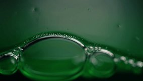 Green water bubbles close up macro 4k shot selective focus - Powered by Shutterstock - Get 15% off with code: PIKWIZARD15