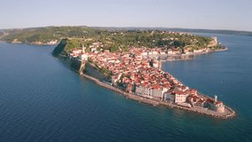 4k drone flight moving to the side and down footage (Ultra High Definition) of summer cityscape of Piran town. Nice landscape of Slovenia’s Adriatic coast with beautiful Venetian architecture. - Powered by Shutterstock - Get 15% off with code: PIKWIZARD15