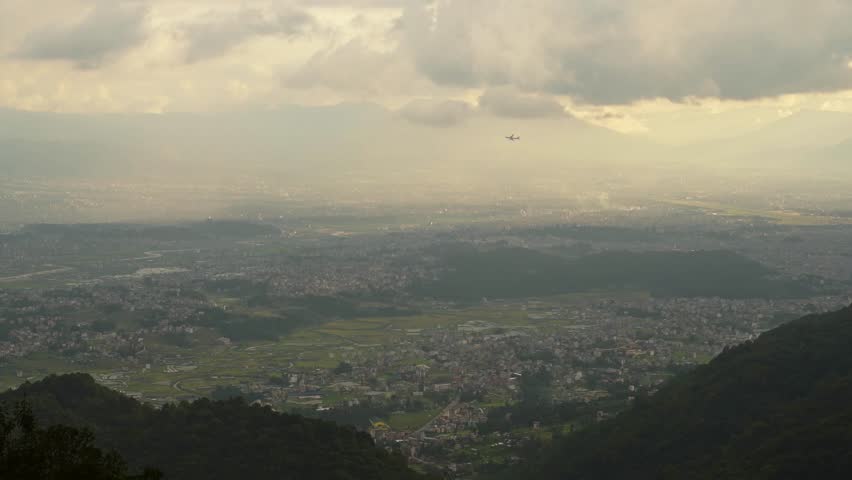 Aerial View of Kathmandu City Cityscape in Nepal at Sunset with Big Beautiful Dramatic Sunset Clouds and Sky and Beautiful Golden Light, Elevated View from Above