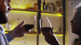 In a stylish bar, two close friends joyfully toast together, clinking their glasses filled with red wine - Powered by Shutterstock - Get 15% off with code: PIKWIZARD15