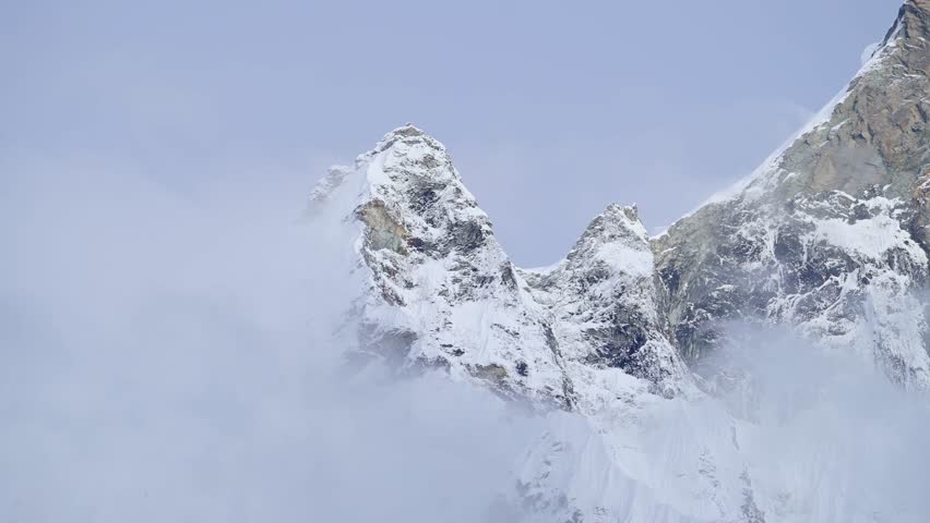Snowcapped Mountains Summit in Clouds, Snowy Winter Himalayas Mountains Covered in Snow in Nepal, Massive Mountain Top in the Cloud in Beautiful Minimal Mountain Scenery