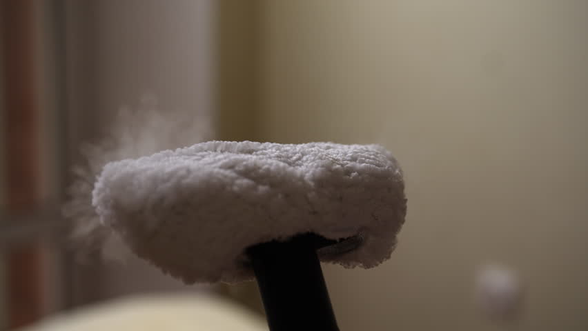 Close-up of steam cleaner emitting cloud of vapor, highlighting power and effectiveness of steam cleaning for sanitizing and refreshing surfaces. Concept of maintenance modern home appliance.