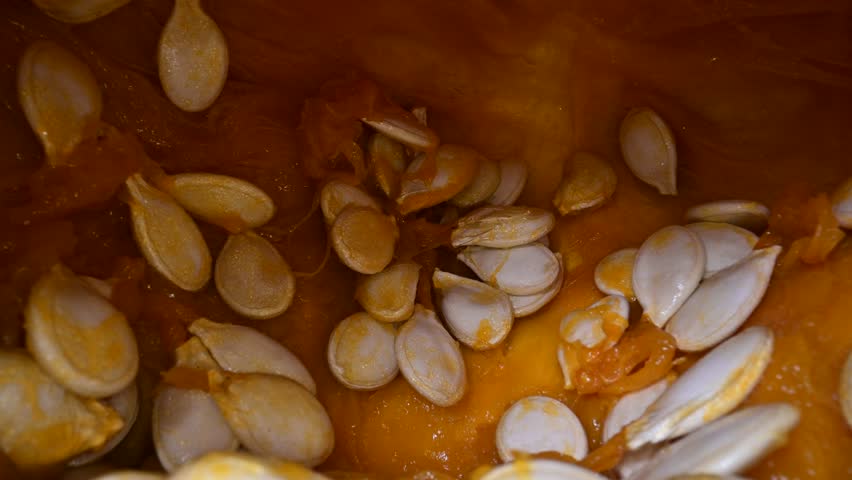 Cutting orange pumpkin with seeds close up. Food photography
