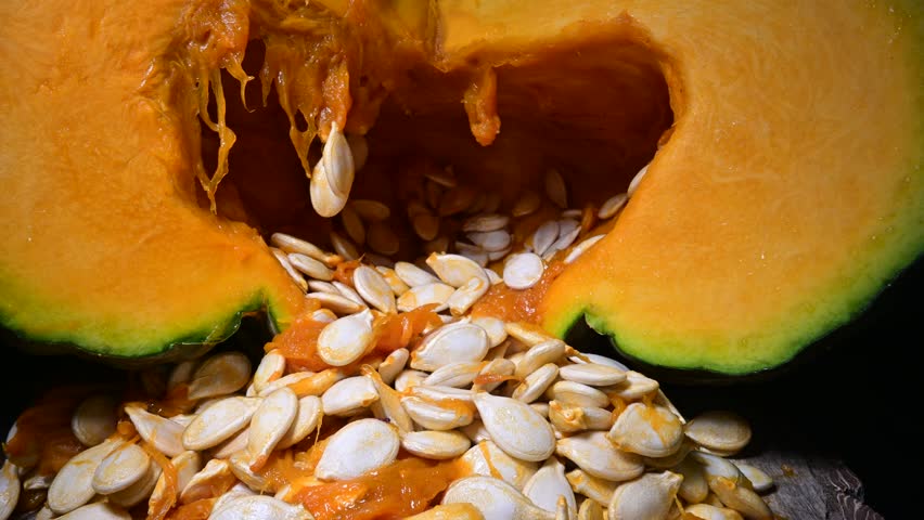Cutting orange pumpkin with seeds close up. Food photography