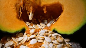 Cutting orange pumpkin with seeds close up. Food photography - Powered by Shutterstock - Get 15% off with code: PIKWIZARD15