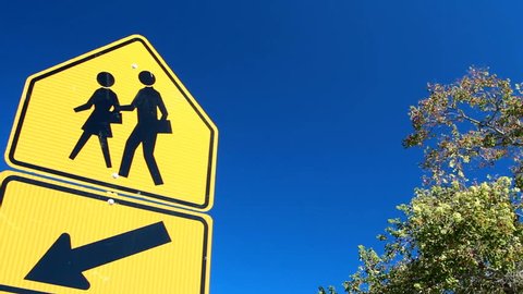 Children crossing sign on blue sky.