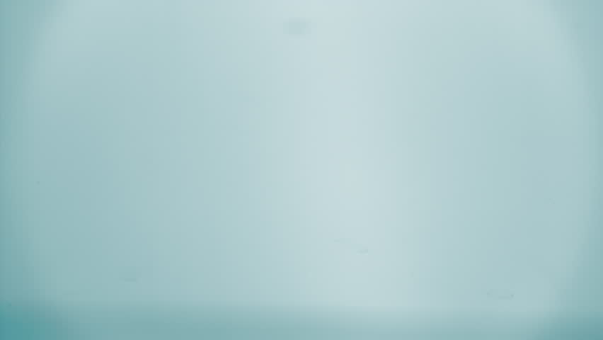 Natural mineral water splashing. Crystal clear drop of cosmetic essence serum falling in slow motion. Body moisturizing cosmetics formulating. Commercial beauty product blue liquid abstract background