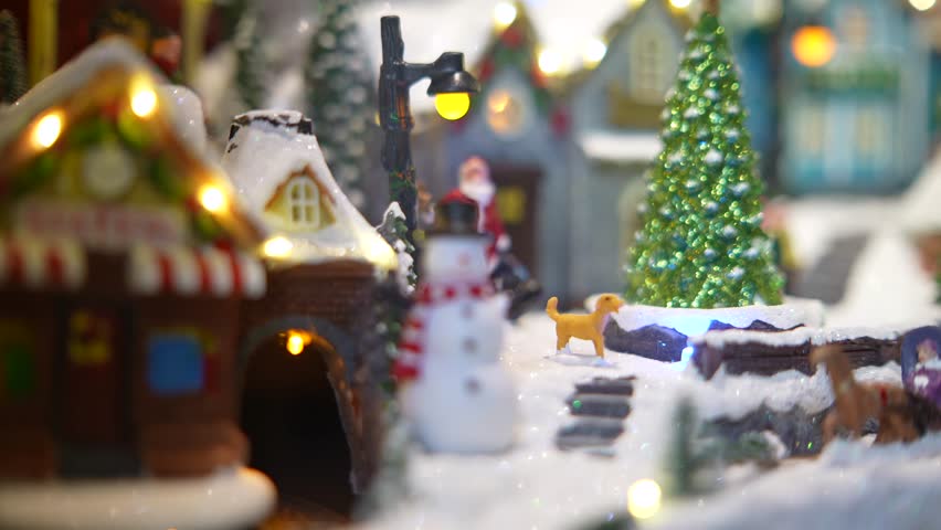 A Charming Winter Village Scene with a Snowman and Beautifully Festive Lights Displayed All Around