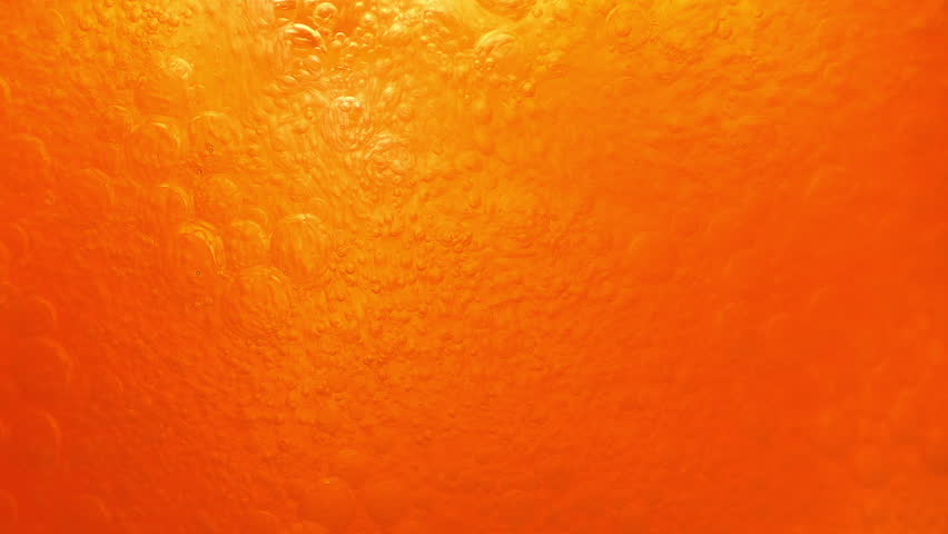 Orange Soda Fizzes In Glass Closeup