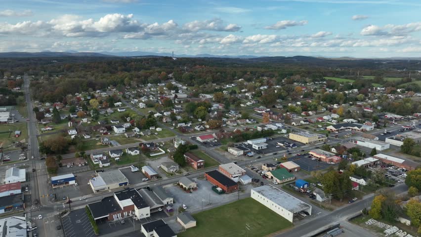 Aerial top down shot of american housing area with single family homes in fall season. Forest landscape with clouds at sky. Virginia, America.