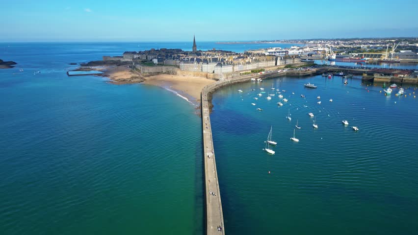 Môle des Noires pier with Saint-Malo in background, Brittany in France. Aerial drone backward, panoramic view