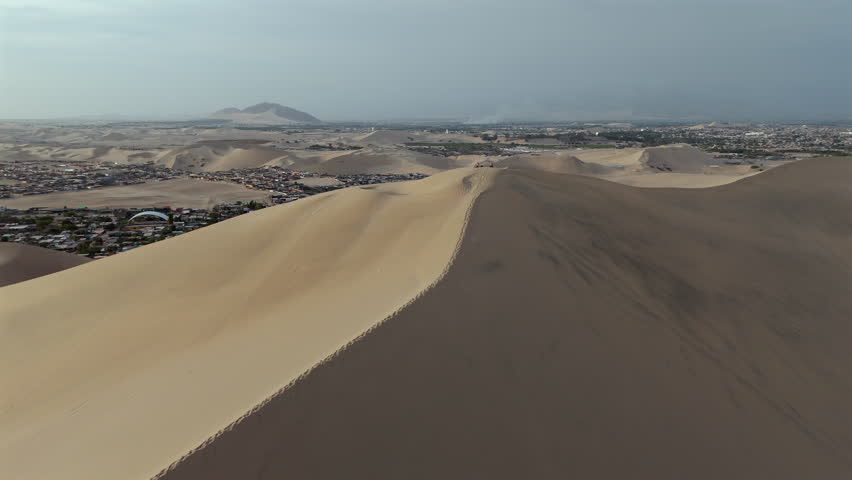Aerial View Of Desert Town Surrounded By Towering Sand Dunes, Huacachina Peru