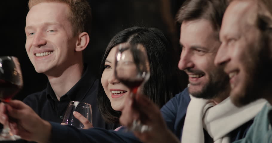 Friends enjoying wine tasting experience in cellar