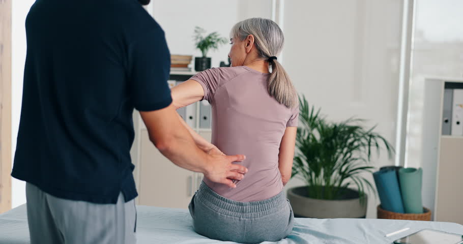 Back pain, physiotherapy and man with mature woman for rehabilitation, recovery and medical service. Healthcare, consulting and chiropractor with patient for physical therapy, support and wellness