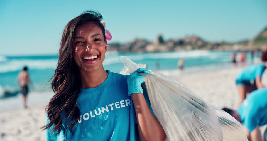 Volunteer, woman and face with plastic bag at beach for ocean cleanup, waste management or sustainability. NGO project, girl or community service for environment conservation or social responsibility