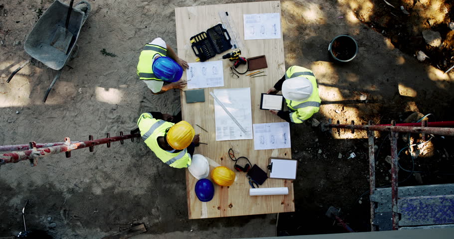 Above, people and talking on construction site with paper, urban development or project management with tech. Engineer team, blueprint or planning at equipment for building renovation in architecture