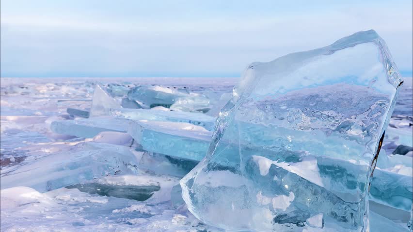 Video of winter landscape of frozen Baikal Lake with ice hummock fields with transparent blue pieces of ice on cold January day. Natural cold background. Winter ice travel and active recreation