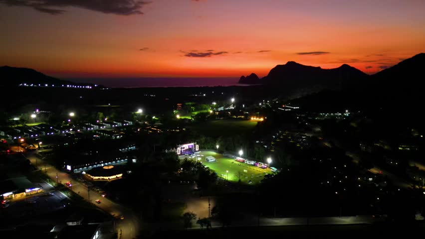 Established Aerial View  of Epic Sunset at the Big Oval Stadium in the Batu Hijau Townsite Area in the Amman Indonesia Mining Complex, Sumbawa Indonesia