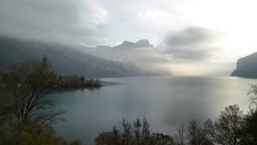Aerial over grass field, Swiss mountains and lake Walen covered in fog - Powered by Shutterstock - Get 15% off with code: PIKWIZARD15