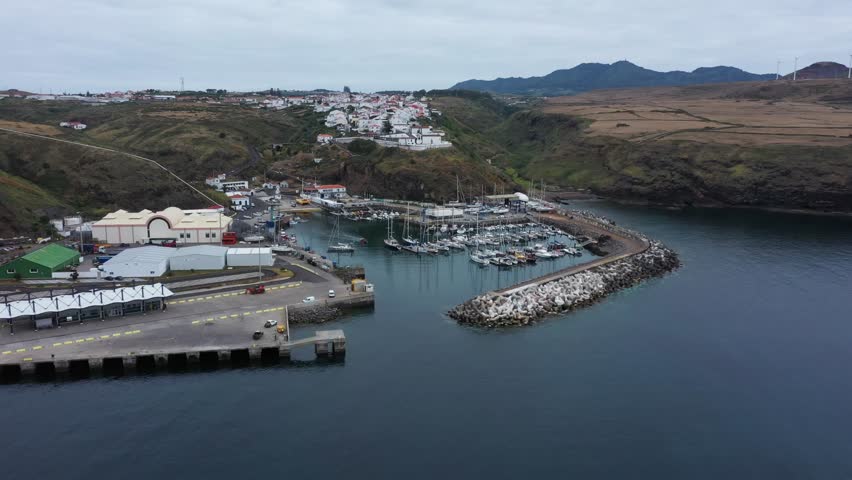 Drone footage capturing the picturesque fishing port of Vila do Porto, located on Santa Maria Island in the Azores, Portugal
