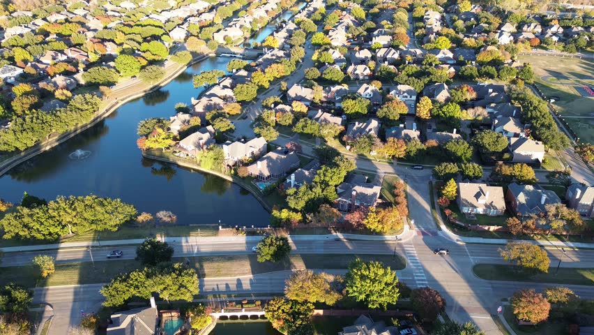 Waterfront residential neighborhood along MacArthur boulevard in Coppell, suburbs Dallas, Texas, colorful fall foliage autumn leaves, cluster two-story house with swimming pool, large backyard. USA