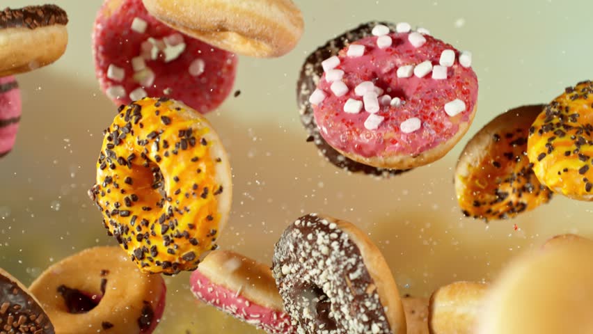 Super Slow Motion of Flying Tasty Donuts with camera movement. Filmed on high speed cinema camera, 1000 fps.