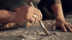 Archaeologist Carefully Excavating with a Brush at a Dig Site - Powered by Shutterstock - Get 15% off with code: PIKWIZARD15
