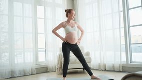 Pregnancy yoga fitness workout training. Pregnant woman practicing yoga at home. Pregnant girl doing sports exercise on yoga mat indoor. Woman with big belly have fitness training practicing asana - Powered by Shutterstock - Get 15% off with code: PIKWIZARD15