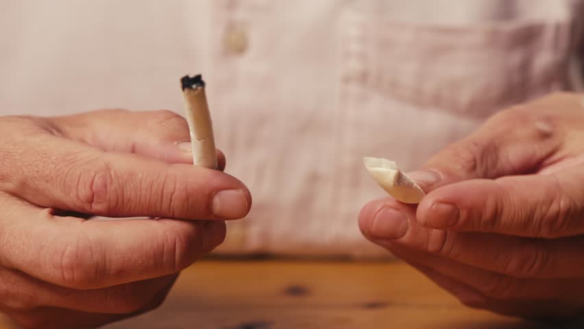 Snus nicotine tobacco close up, pack of tobacco for gum. unhealthy addiction. Man opening box with snus and taking one. 